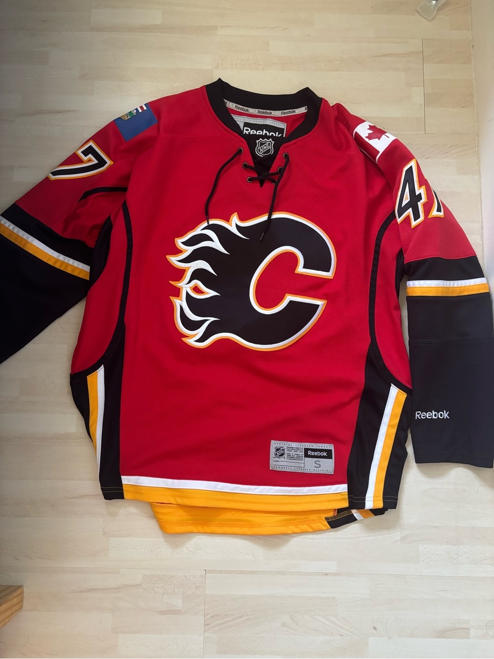 Reebok Red, Black and Yellow Hockey Jersey Tag Detail
